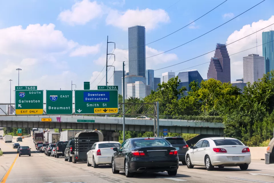 Traffic on freeway in Houston, Texas with downtown buildings in background